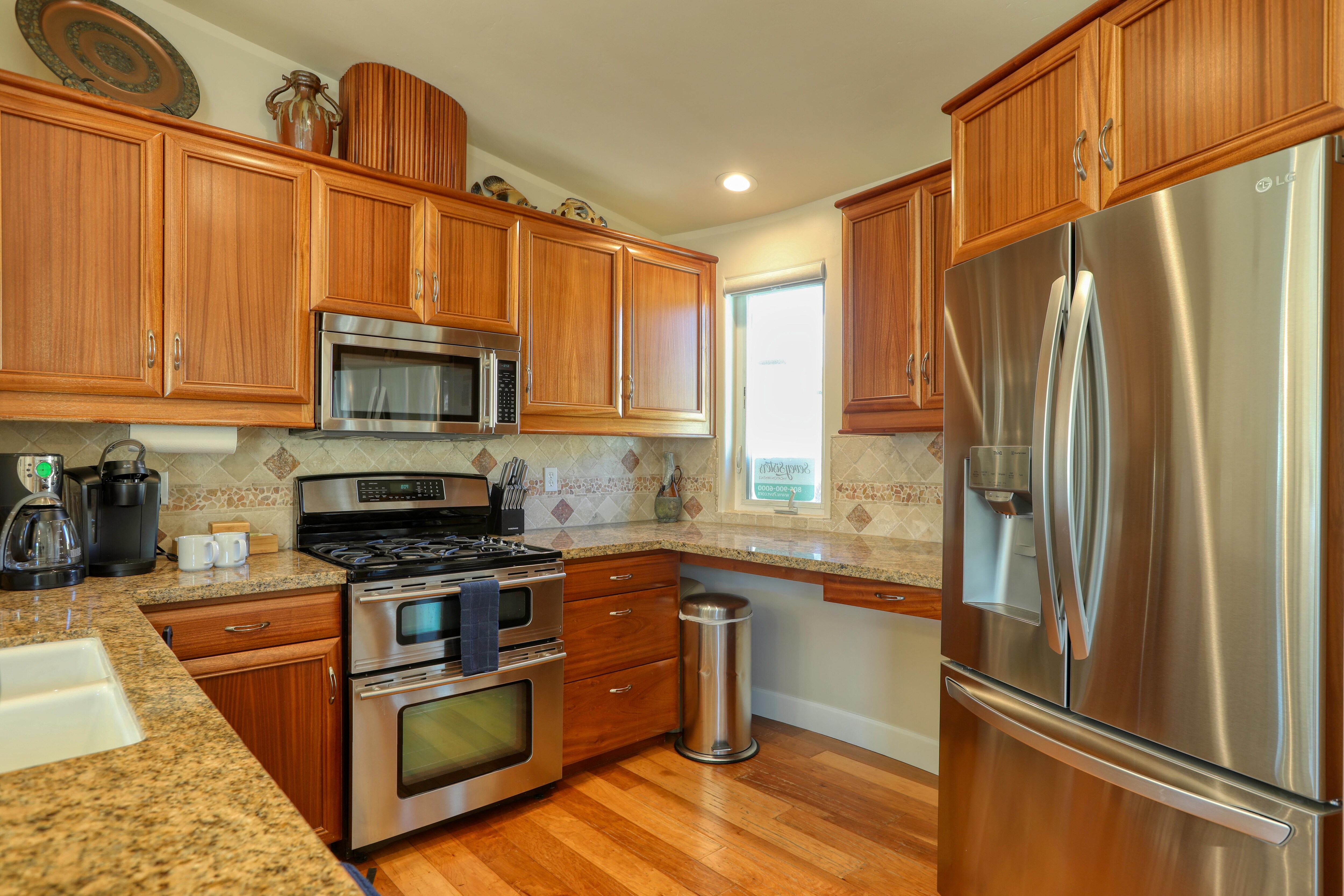 Stainless steel kitchen appliances.  Kitchen area extends into great room.