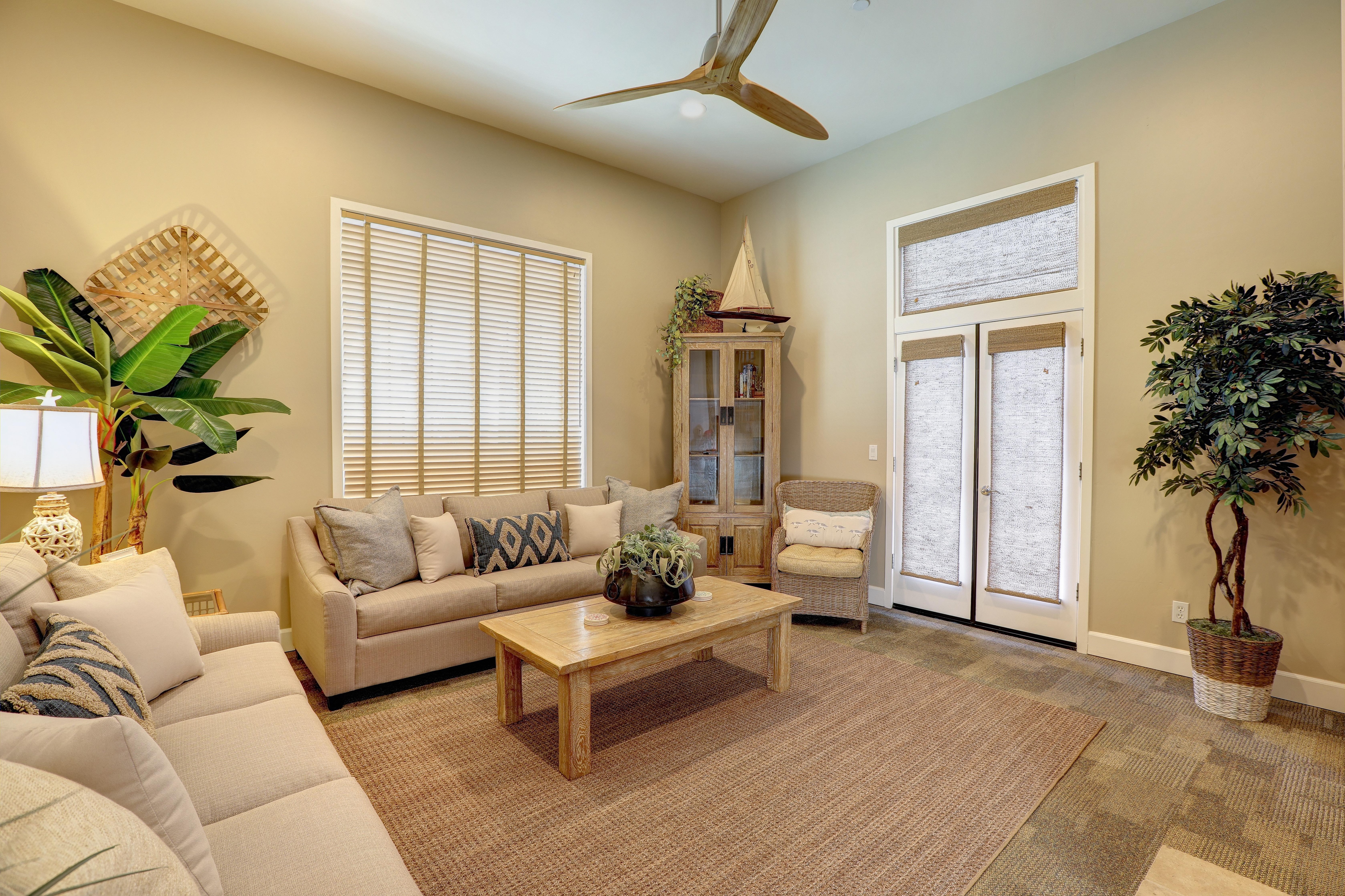 French doors open to patio. There is a glimpse of ocean view from front patio.