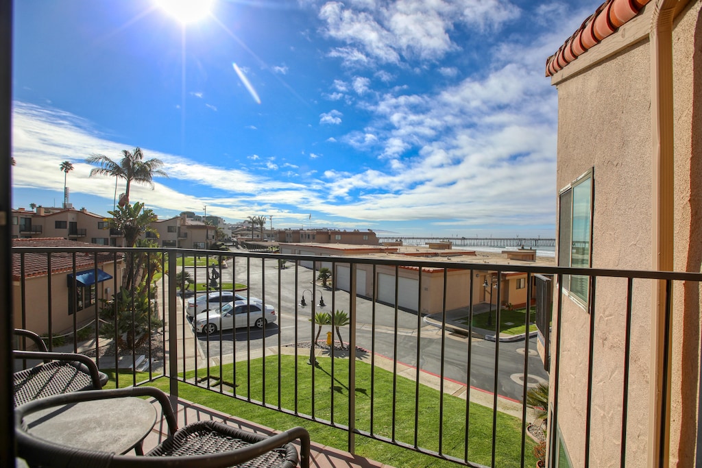 Step outside to your private deck, where you can enjoy the fresh ocean breeze and a serene view of the lush, grassy lawn below.