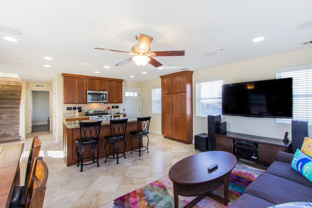 Open concept living room with large TV