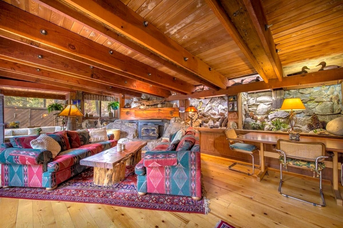 Living room features traditional decor with a rustic stone wall.