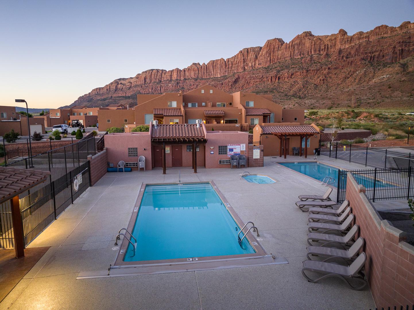 Community pool and hot tub located near the unit. Relax while taking in the dramatic views of the Moab Rim. 