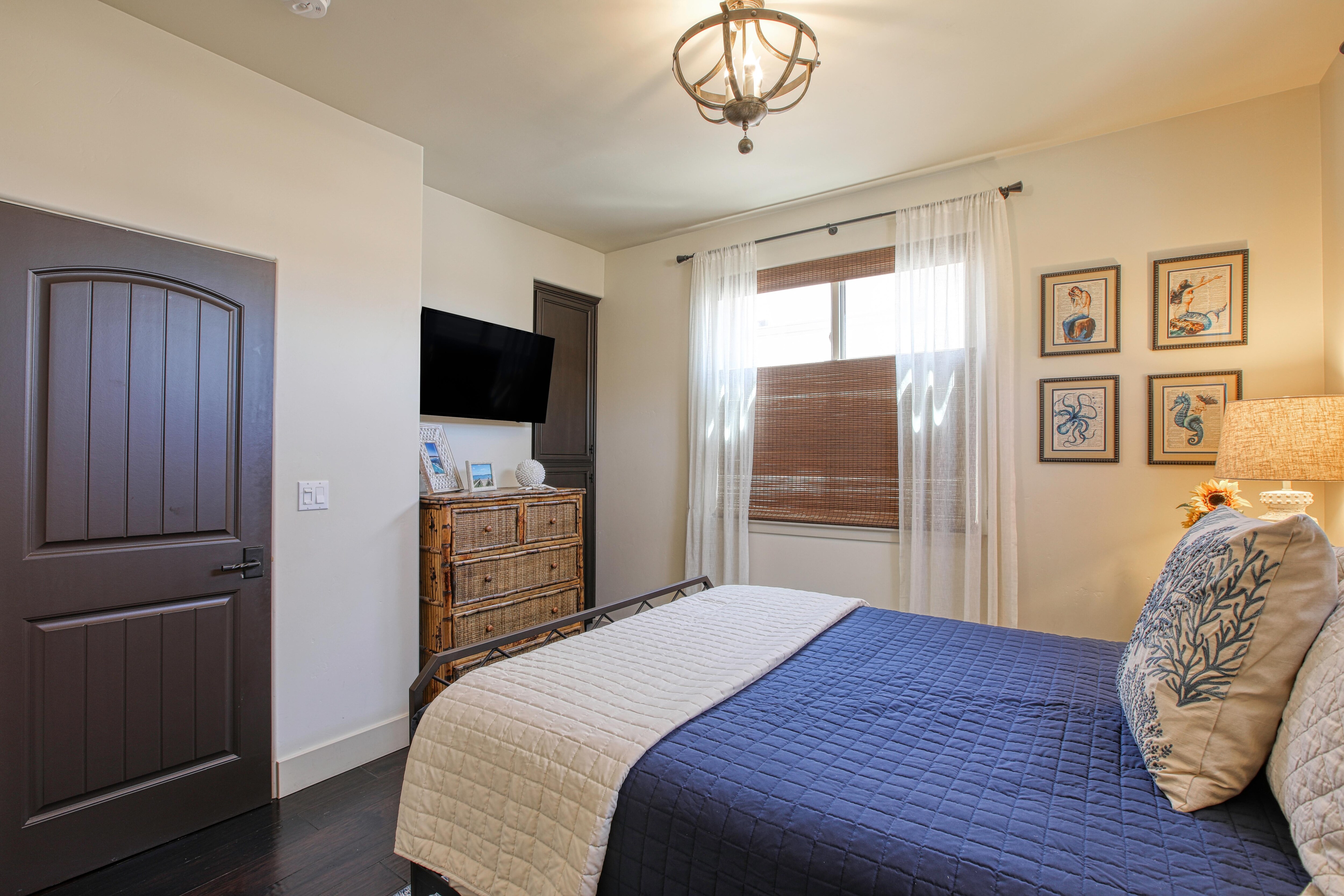 This bedroom also has a hanging closet and dresser for clothes storage. 