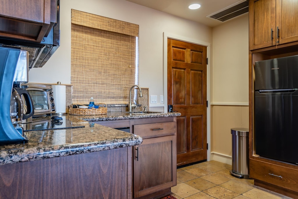 Kitchenette with granite countertops 