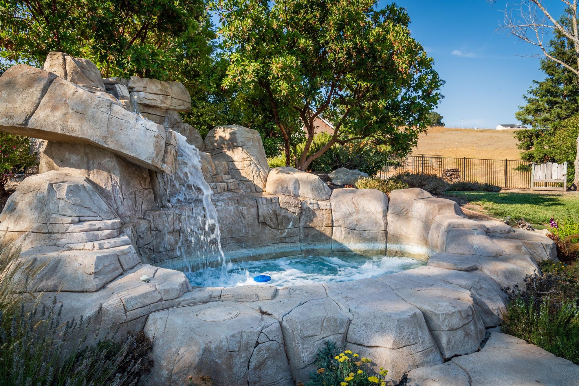 One-of-a-kind custom stone spa with waterfall