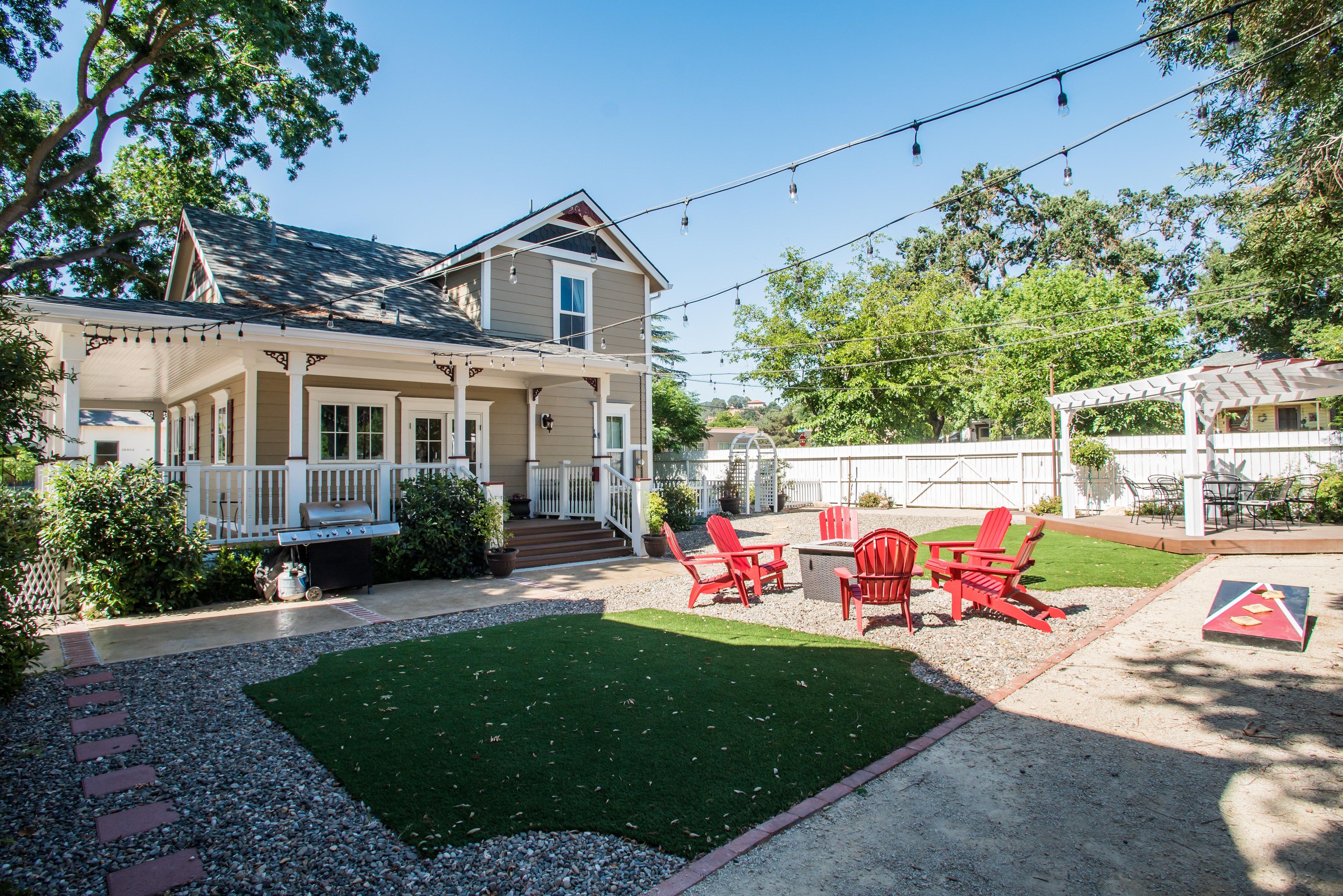 Large backyard featuring a gas Fire Pit for cozy evening. 