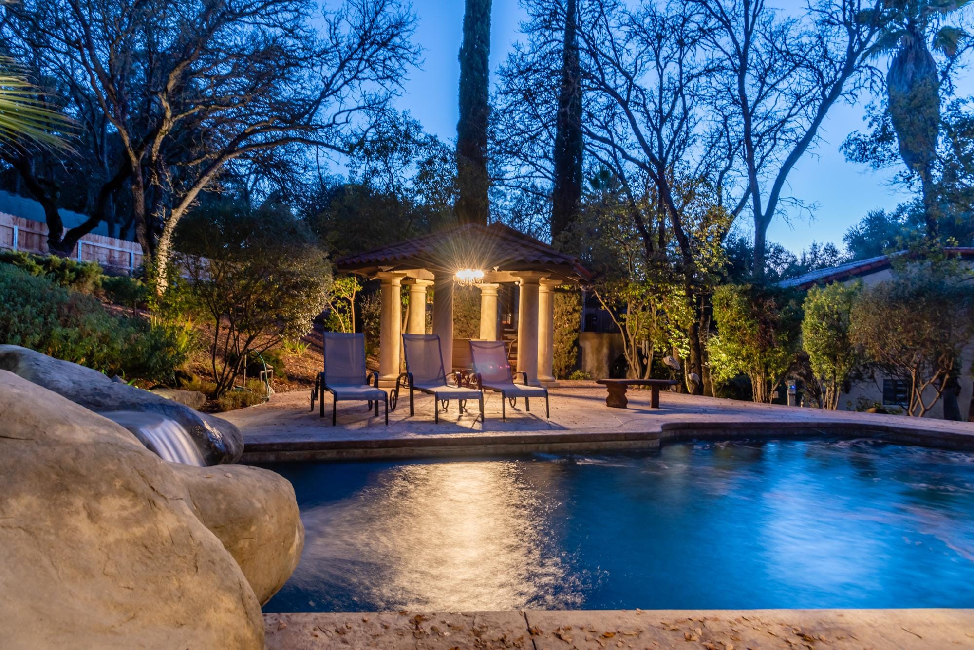 Relax Pool Side while enjoying the soothing sounds of the waterfall