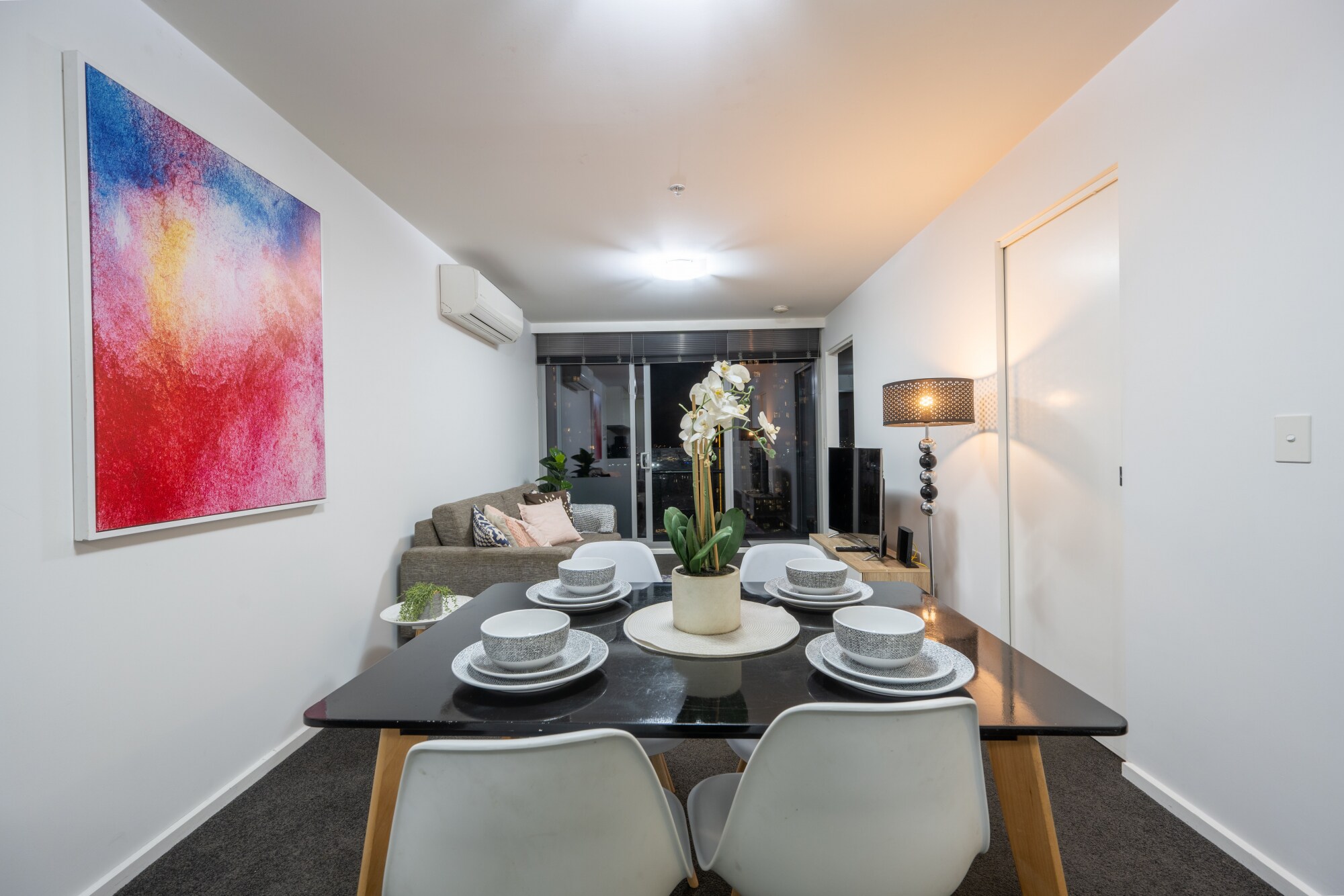 Wine and dine within the apartment with a stylish table set for four
