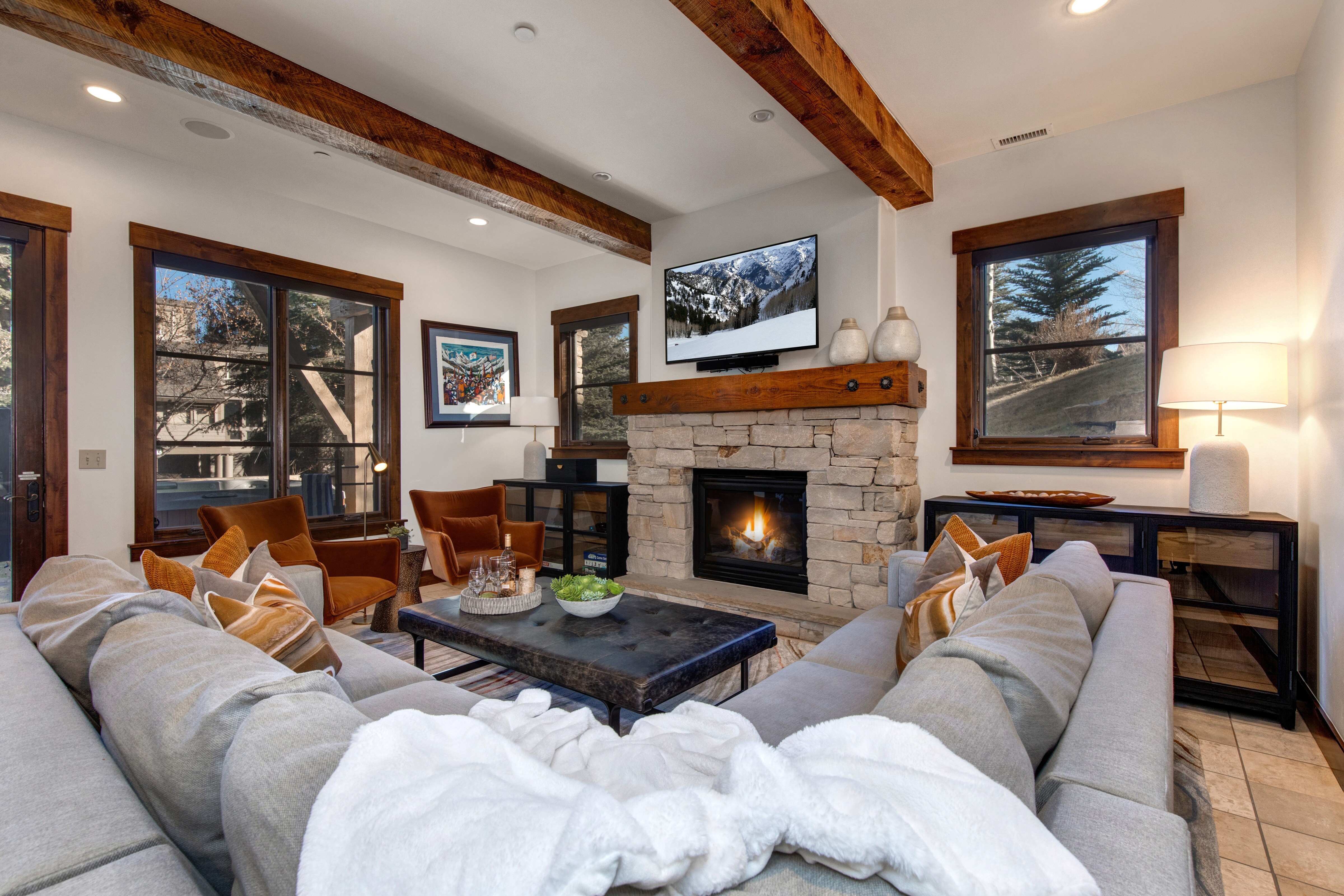 Lower Level Family Room with Cozy Seating, 55" Smart TV, Gas Fireplace and Deck & Hot Tub Access