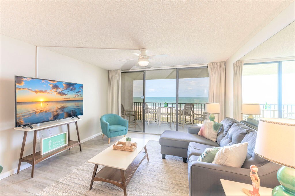 Coastal chic living room with 65" Smart TV, pullout couch and gorgeous views of the water!