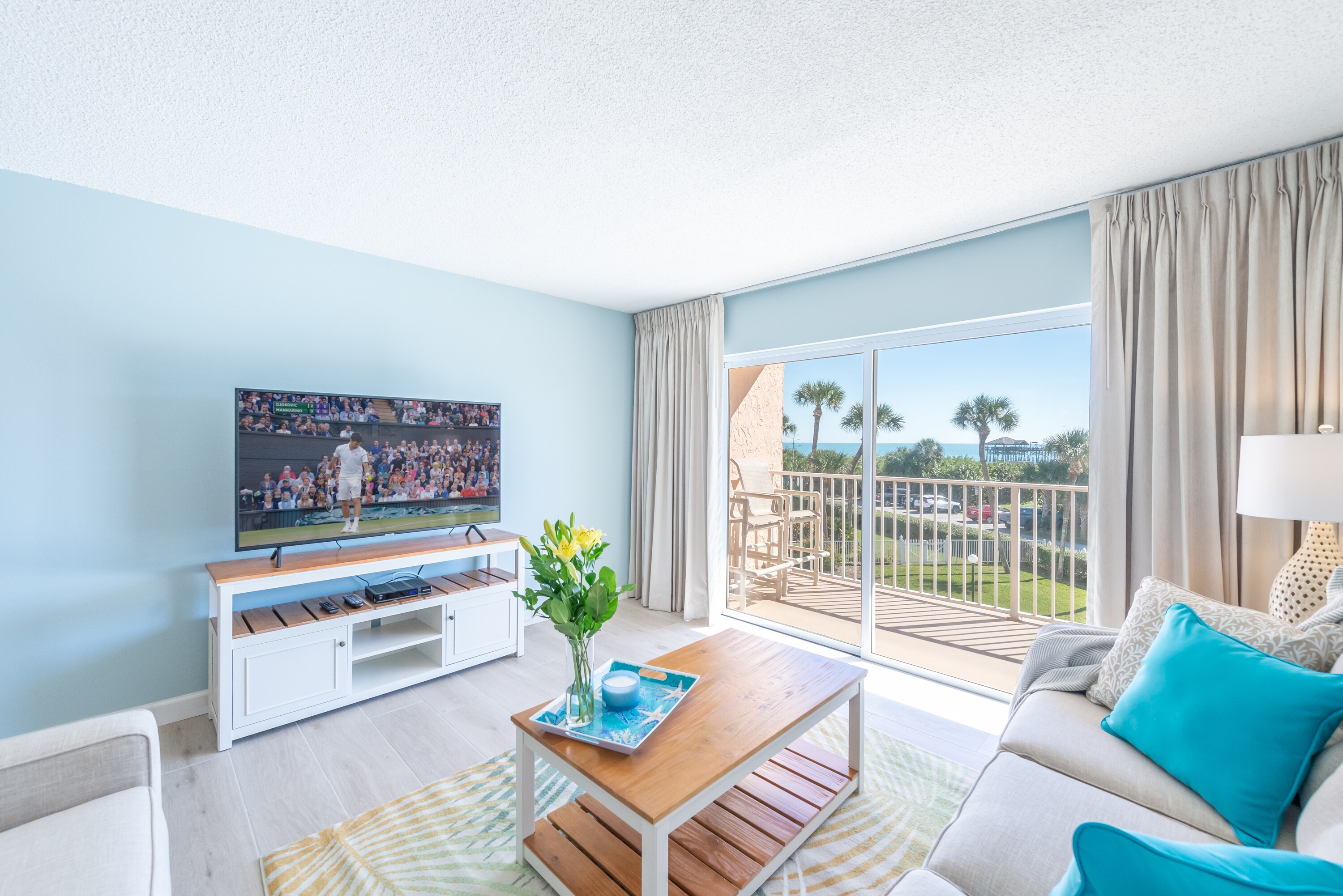 Big screen TV and a view of the ocean. Walk right out to the patio.