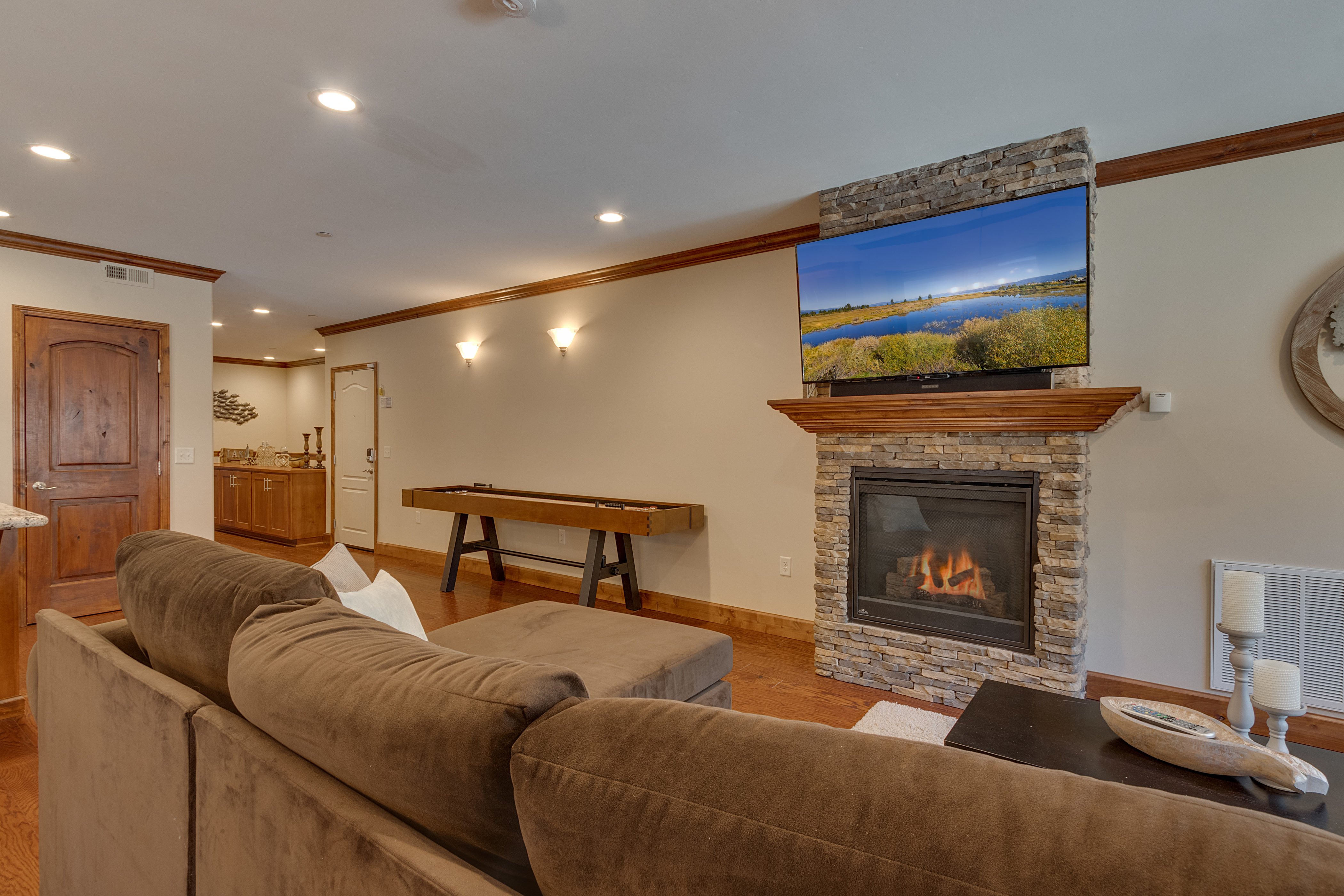 Living area with fireplace, flat screen tv, and shuffleboard