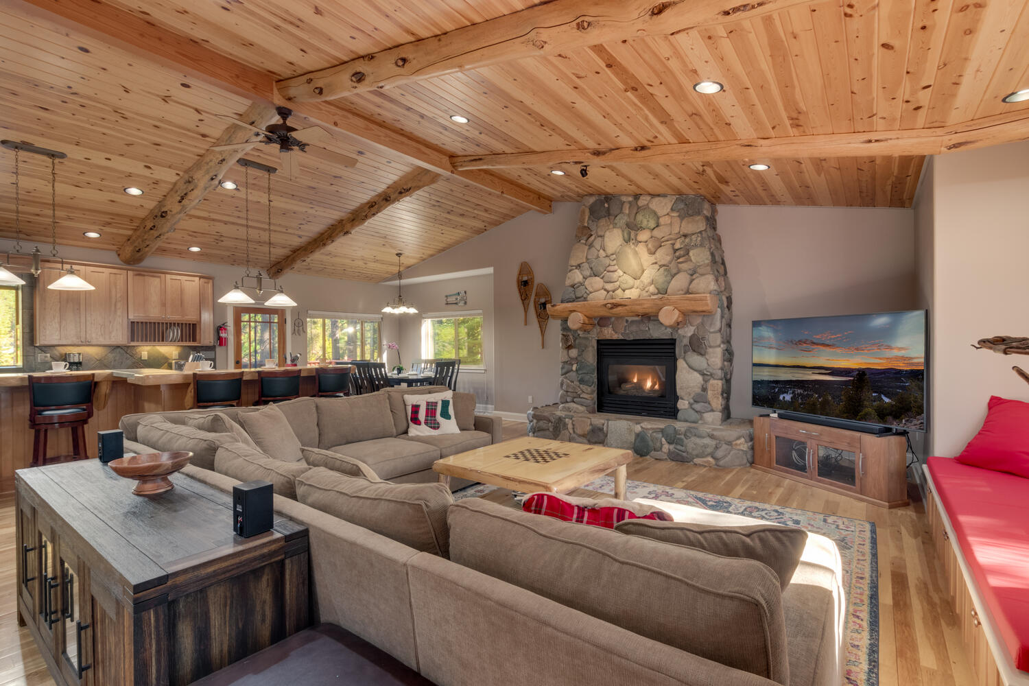 Living area with wood ceiling, flat screen, and fireplace