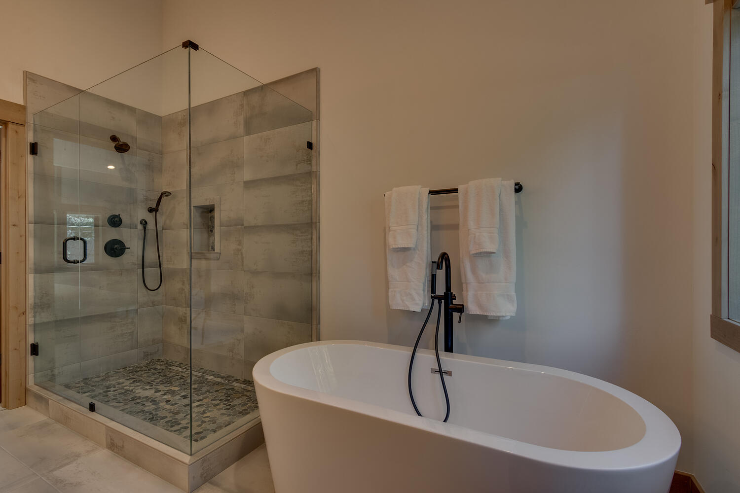 Bathroom with soaker tub and glass enclosed shower