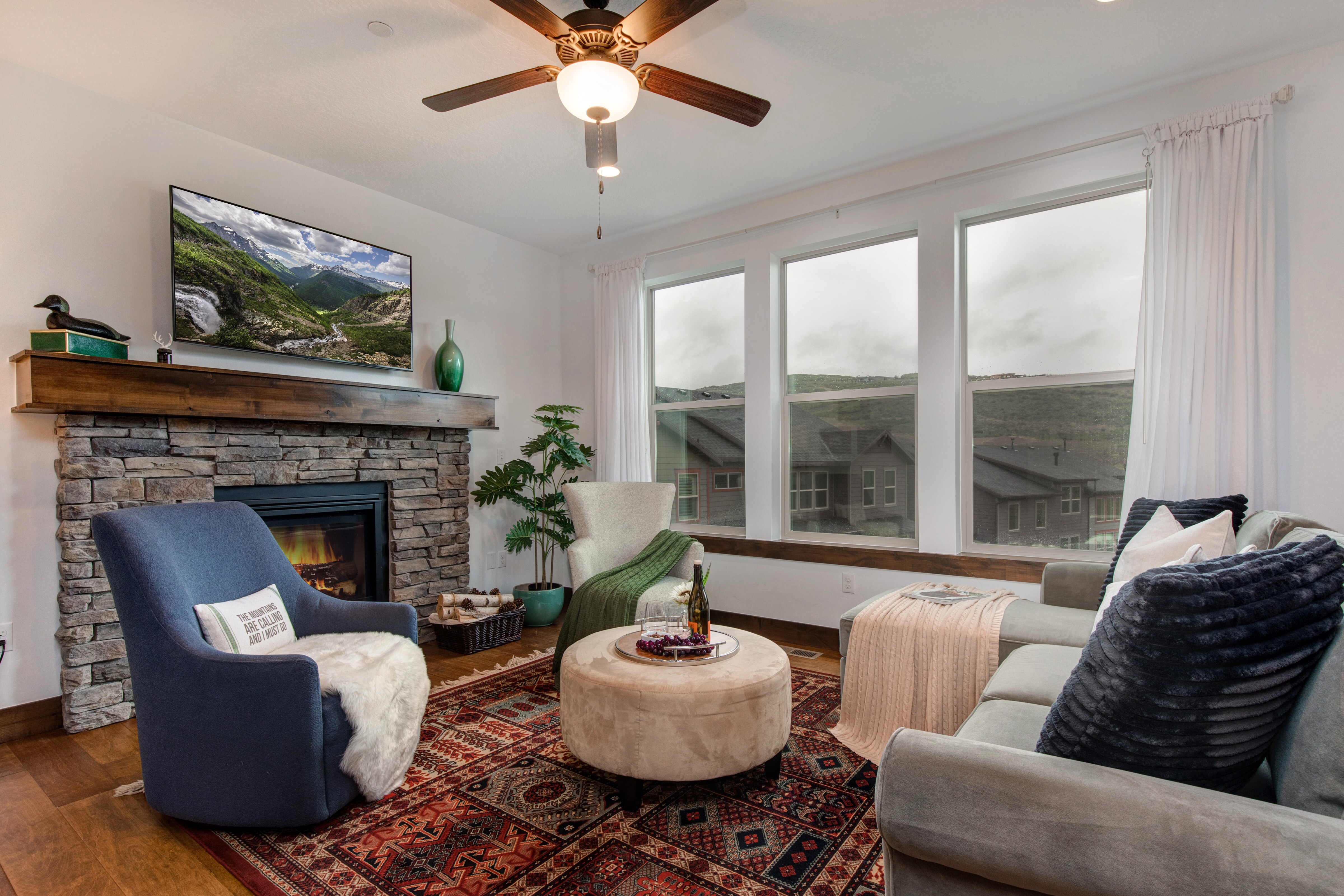 Main Level Living Room with gas fireplace, plush furniture, and smart tv
