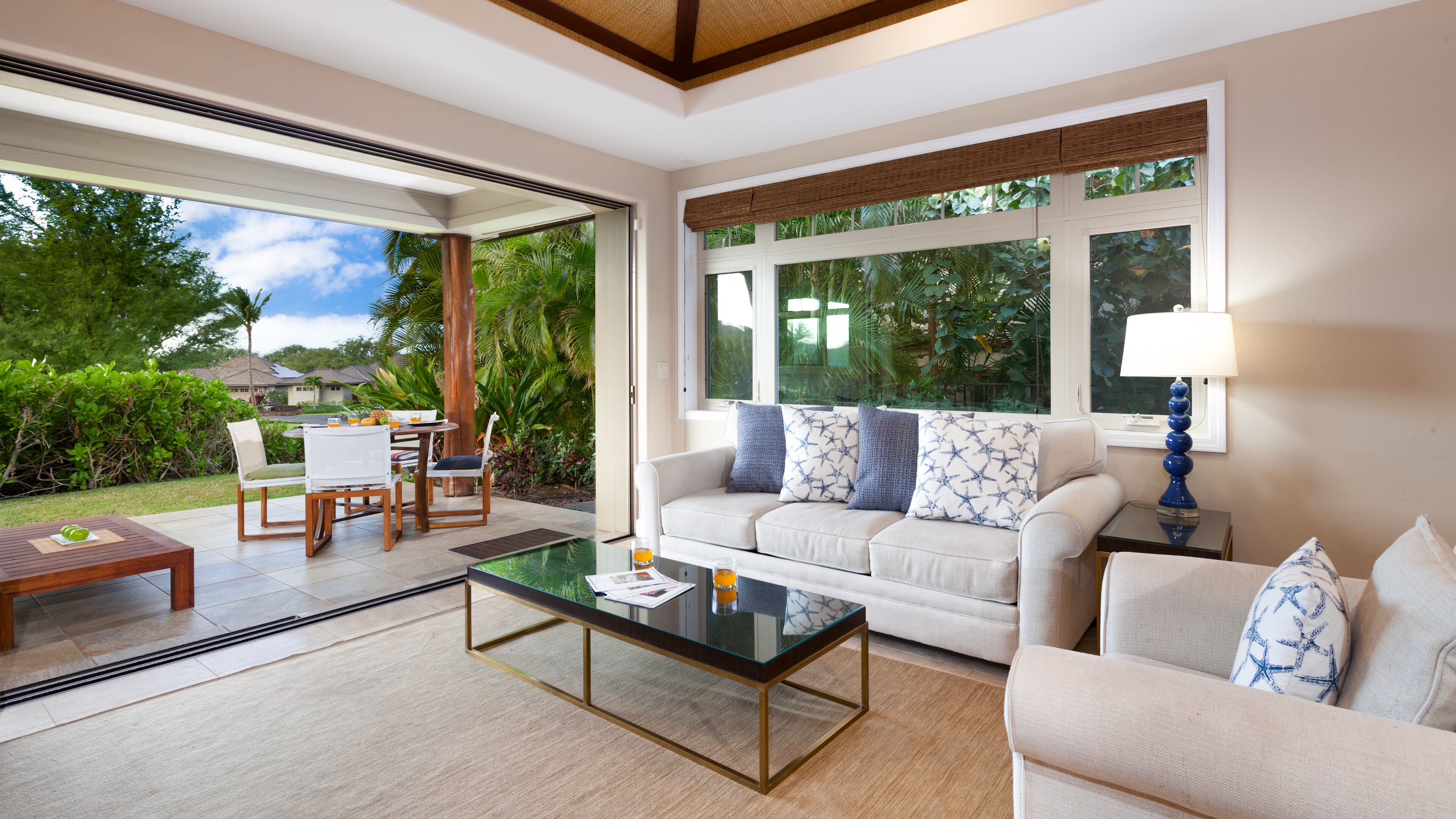 Open Concept Living Room opens to Lanai and lush gardens