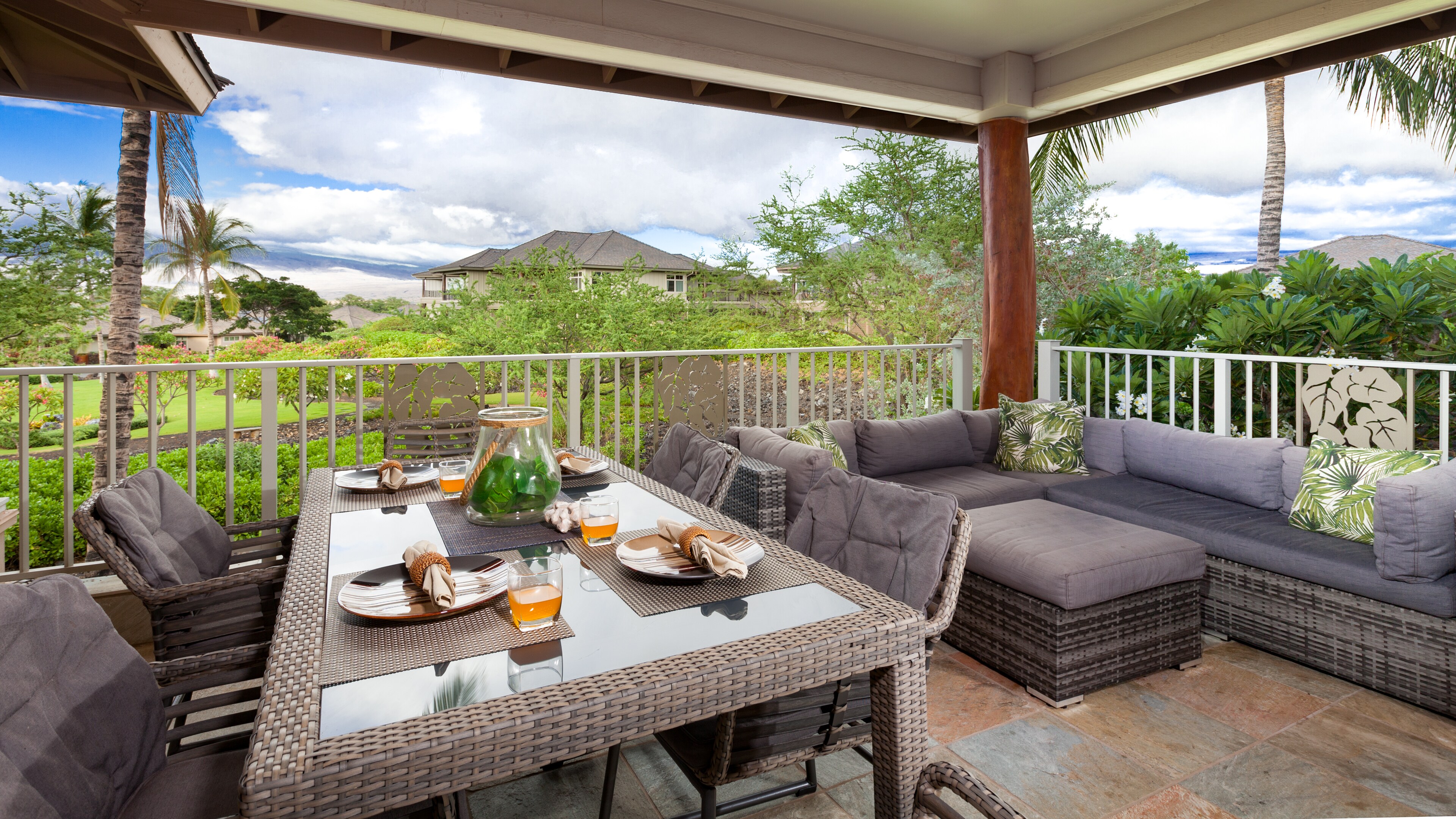 Large covered lanai with view of the putting green and gardens and Kohala Mountain