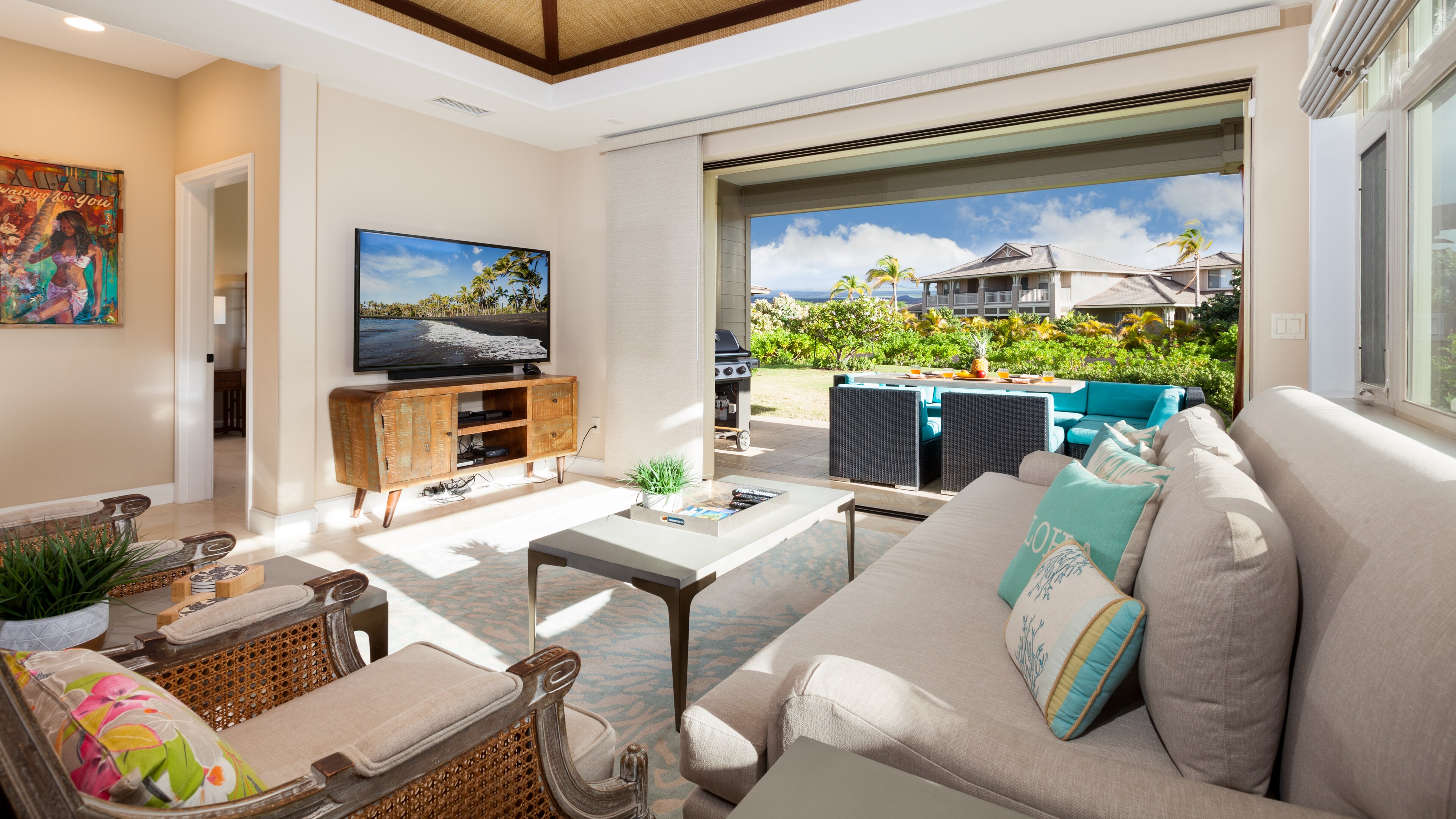 Large living room with pocket door to lanai outdoor dining and living area