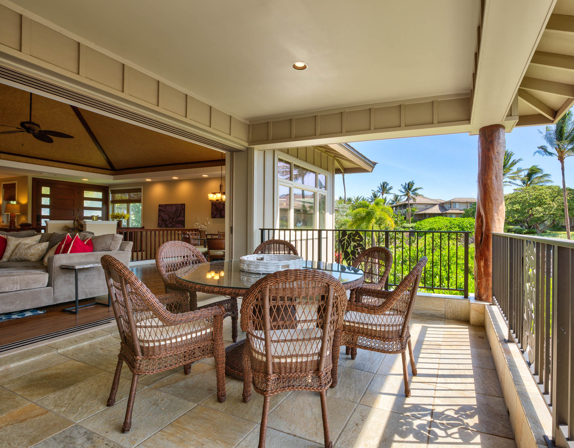 Large open concept indoor living room opens into lanai outdoor living room