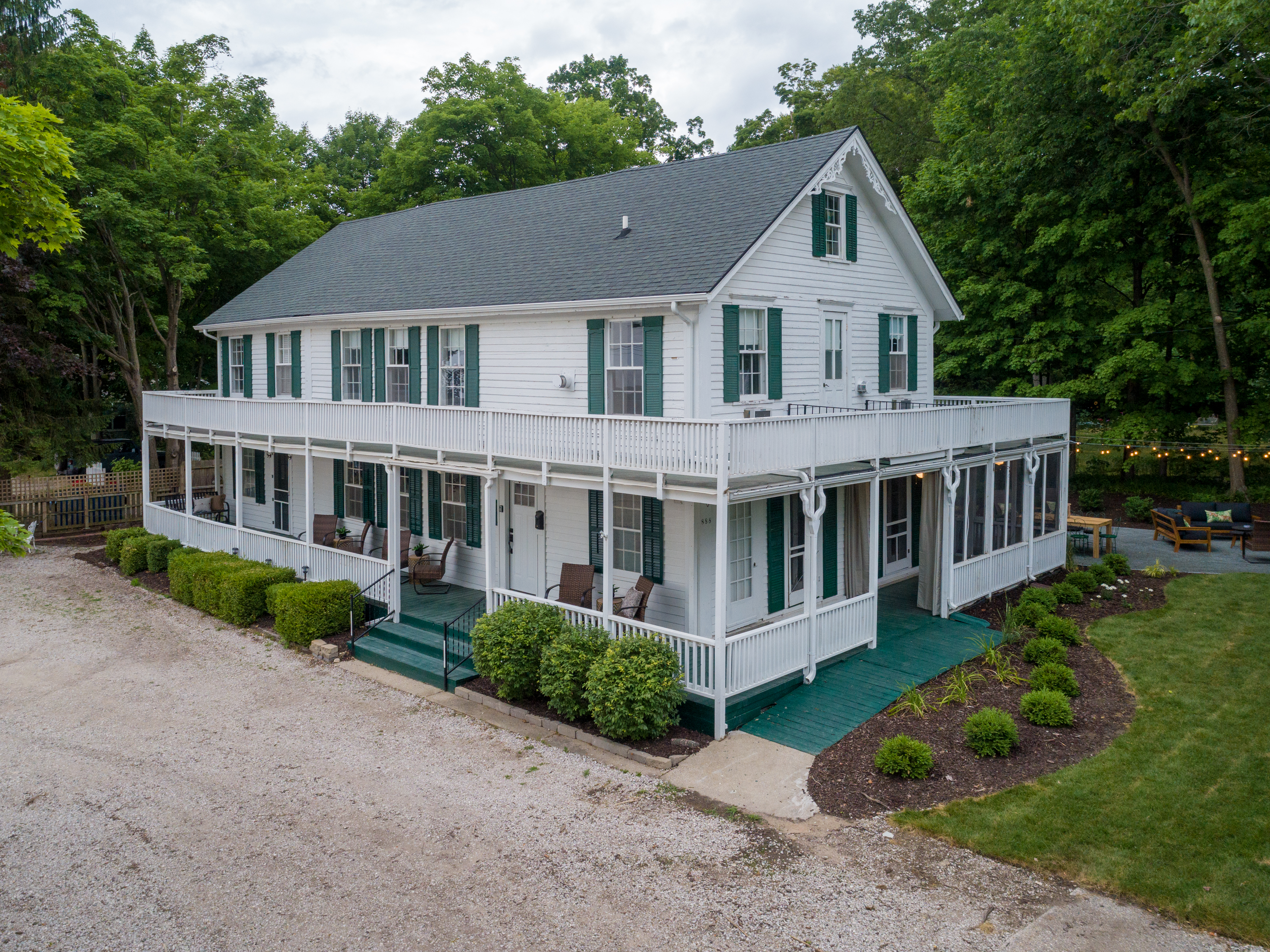 This eight-bedroom, nine-bathroom cottage boasts a gorgeous wraparound porch and outdoor custom patio.
