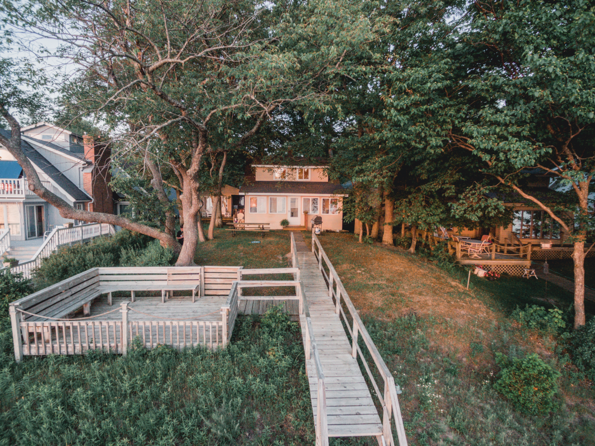 This vintage, four-bedroom gem of a cottage is located right on Lake Michigan with a deck overlooking the shoreline with stairs to private beach access.